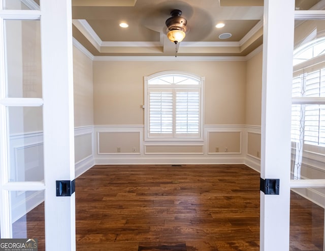 spare room with ceiling fan, ornamental molding, wood finished floors, and wainscoting