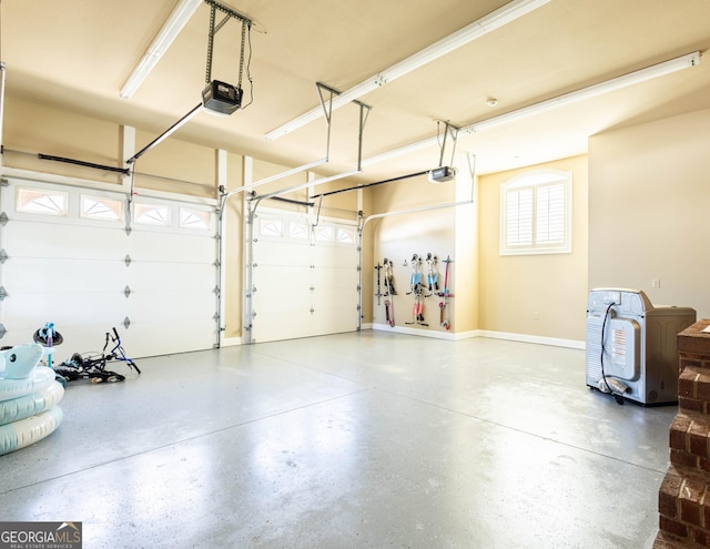 garage with baseboards and a garage door opener