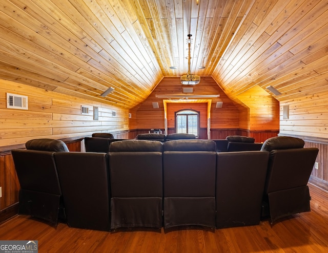 cinema room featuring wooden ceiling, wood walls, vaulted ceiling, and wood finished floors