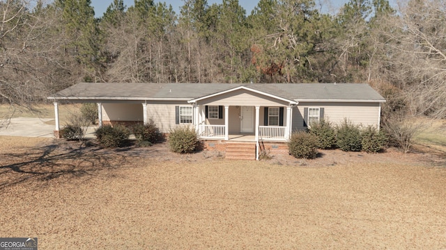 view of front facade with a porch and driveway