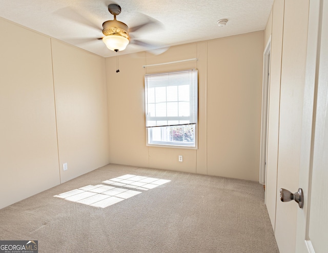 interior space with a ceiling fan and a textured ceiling