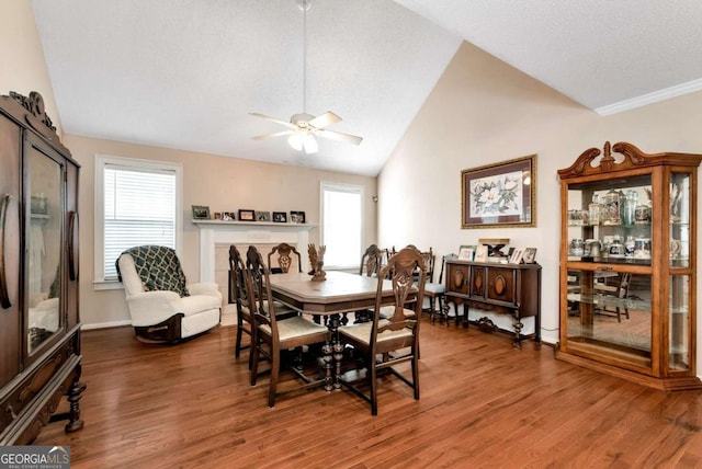 dining area with a wealth of natural light, vaulted ceiling, and wood finished floors