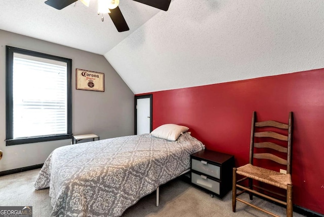 bedroom featuring lofted ceiling, carpet floors, a textured ceiling, and baseboards