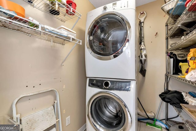 laundry room with laundry area and stacked washer and clothes dryer