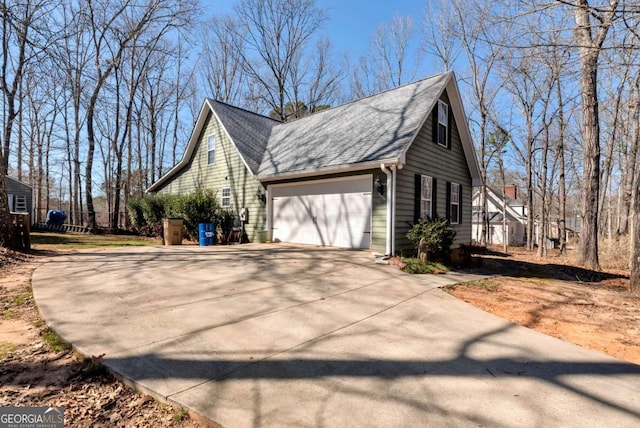 view of home's exterior featuring a shingled roof, driveway, and an attached garage