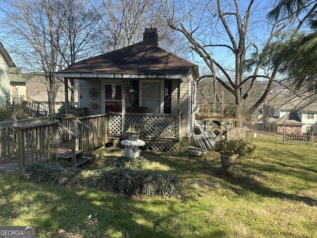 view of front facade with a front lawn and a chimney