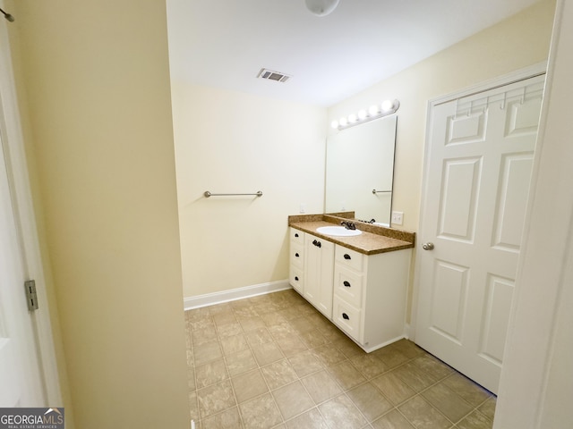 bathroom featuring visible vents, vanity, and baseboards