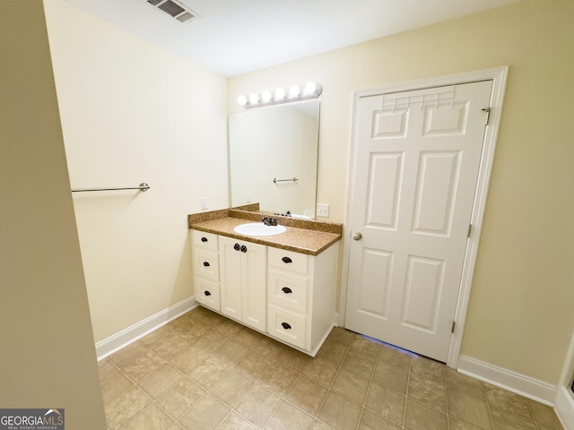 bathroom featuring baseboards, visible vents, and vanity