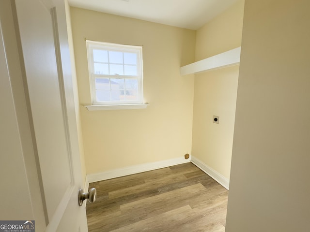 washroom featuring laundry area, wood finished floors, electric dryer hookup, and baseboards