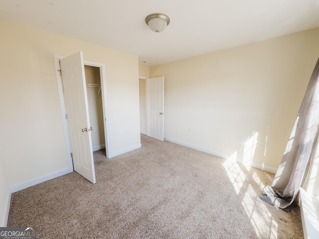 unfurnished bedroom featuring a closet, carpet, and baseboards