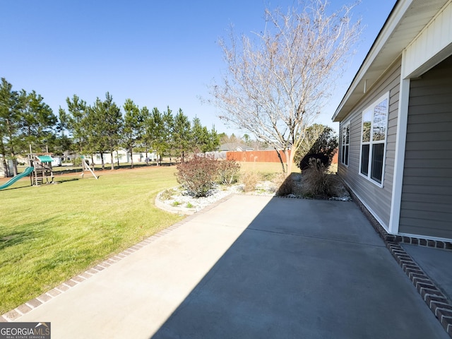 view of patio featuring fence and a playground