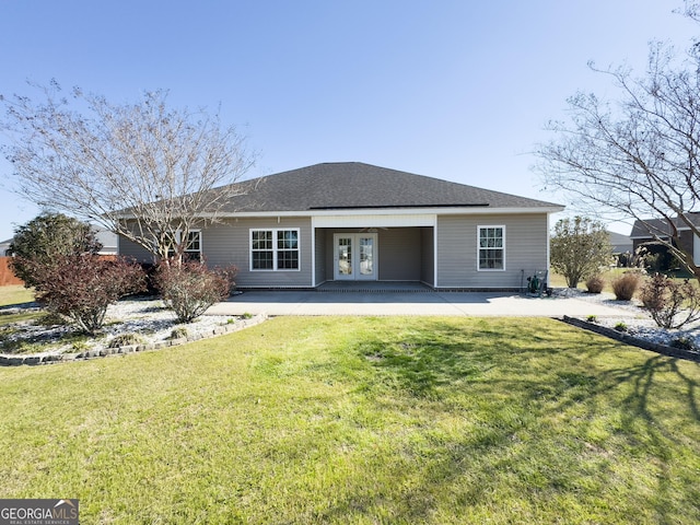 back of house with a yard, a shingled roof, a patio, and french doors