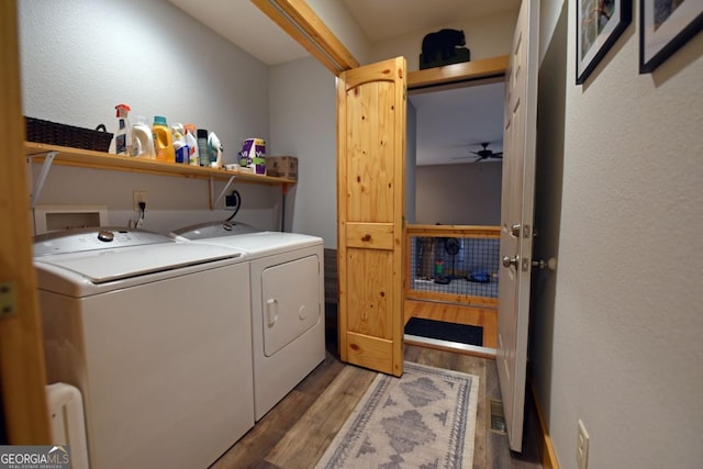 clothes washing area featuring a textured wall, laundry area, wood finished floors, a ceiling fan, and washer and dryer