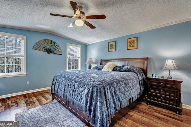 bedroom with crown molding, baseboards, vaulted ceiling, and wood finished floors