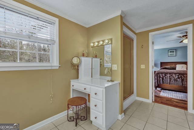 office featuring light tile patterned floors, baseboards, and crown molding