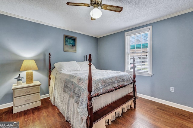 bedroom with ornamental molding, baseboards, and wood finished floors