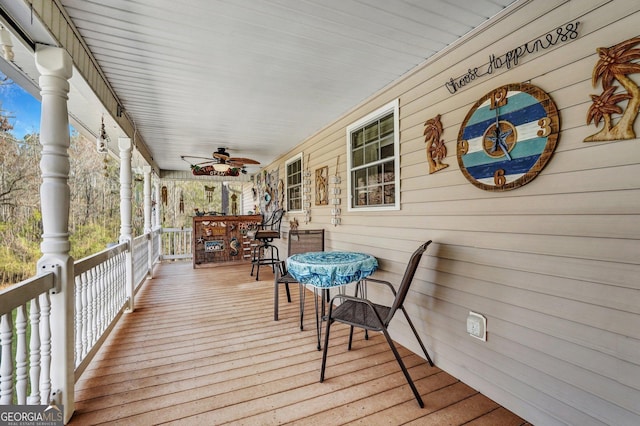 wooden deck with covered porch and ceiling fan