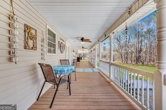 wooden terrace with a ceiling fan and covered porch