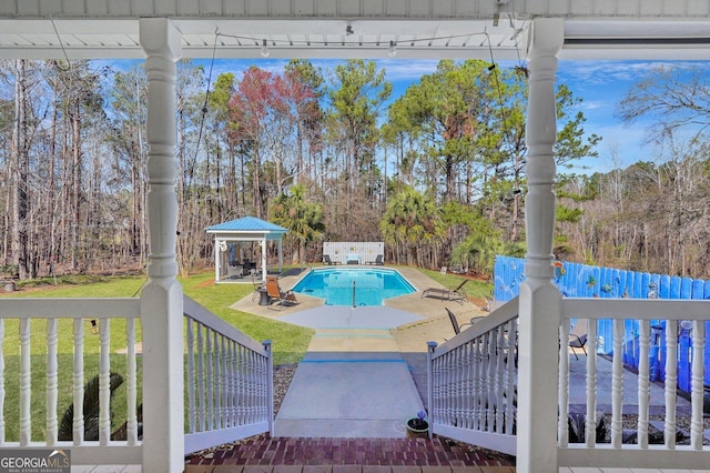 view of swimming pool featuring a yard, a patio area, a fenced in pool, and a gazebo