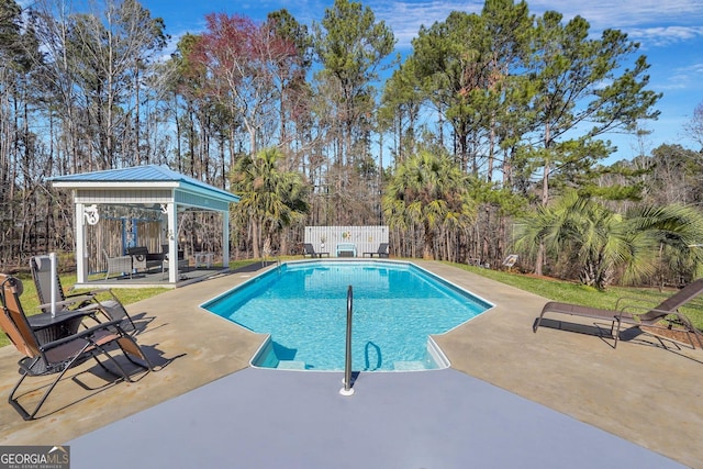 outdoor pool featuring a patio, a gazebo, and fence