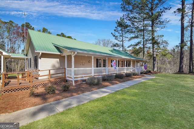 view of front of home featuring metal roof, a porch, and a front yard