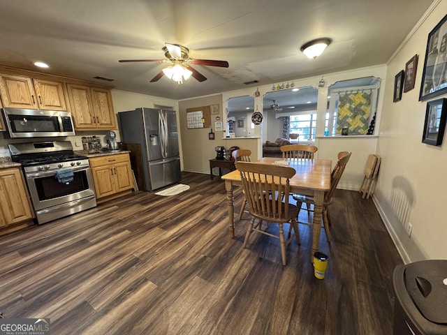 kitchen featuring baseboards, ceiling fan, appliances with stainless steel finishes, brown cabinets, and dark wood-style flooring