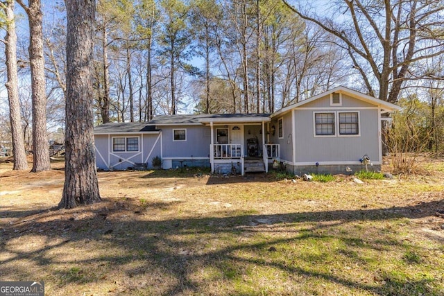 view of front of home with a front yard and covered porch