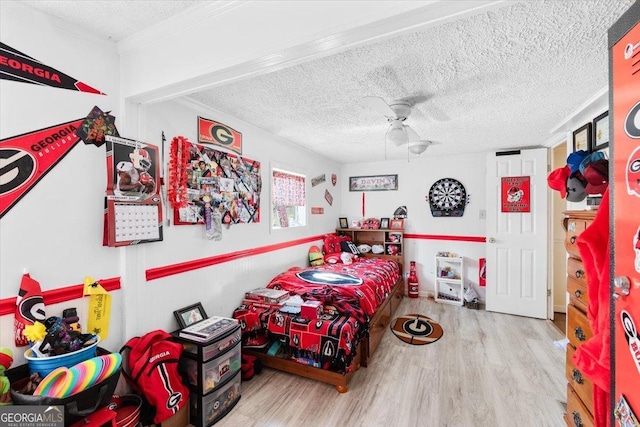 bedroom featuring ceiling fan, a textured ceiling, and wood finished floors