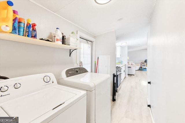 laundry area featuring light wood finished floors and separate washer and dryer