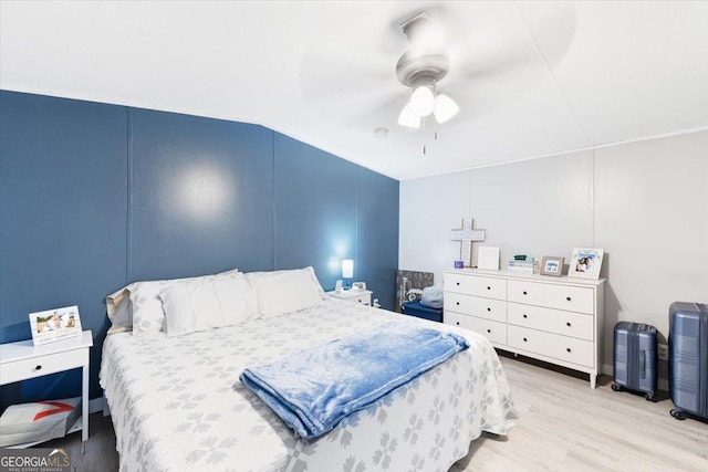 bedroom featuring lofted ceiling, ceiling fan, and wood finished floors