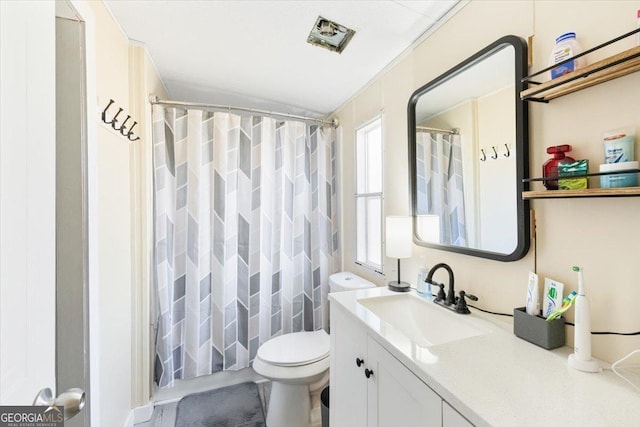 bathroom with toilet, curtained shower, and vanity