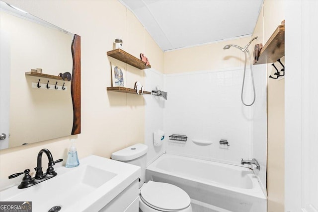 full bathroom featuring washtub / shower combination, vanity, and toilet