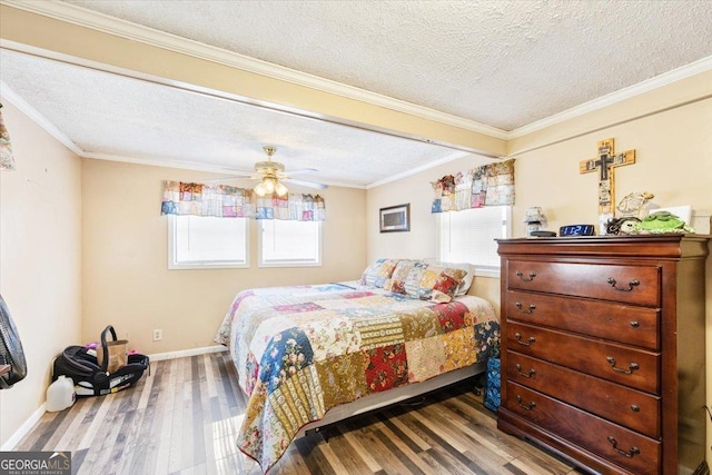 bedroom with crown molding, a ceiling fan, a textured ceiling, wood finished floors, and baseboards