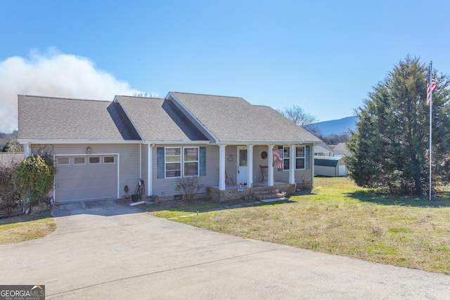 single story home with a front yard, covered porch, driveway, a garage, and a mountain view