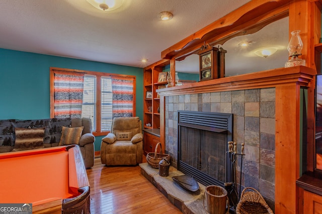 living room featuring hardwood / wood-style flooring and a fireplace