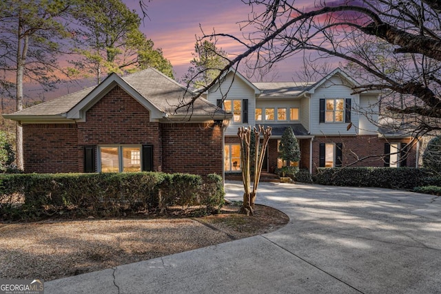 traditional-style home with brick siding and driveway