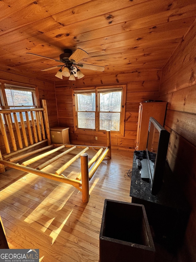 unfurnished bedroom with wooden ceiling, multiple windows, and hardwood / wood-style flooring