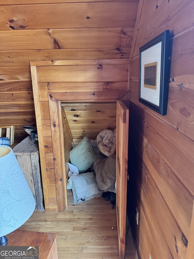 unfurnished bedroom featuring wood walls and wood finished floors