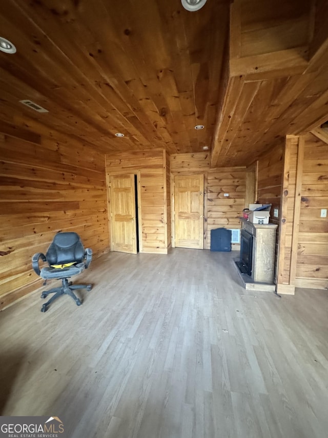 additional living space featuring wood ceiling, visible vents, wood walls, and wood finished floors