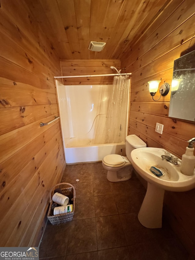 full bath with wooden ceiling, tile patterned flooring, toilet, wooden walls, and shower / bathtub combination with curtain