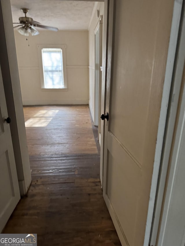 corridor with hardwood / wood-style floors