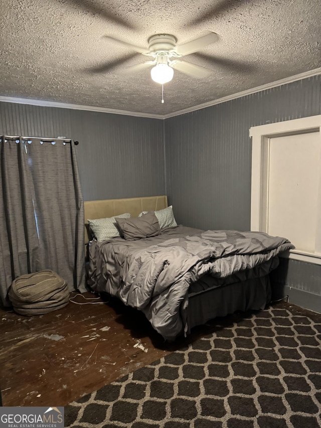 bedroom featuring ornamental molding, ceiling fan, and a textured ceiling