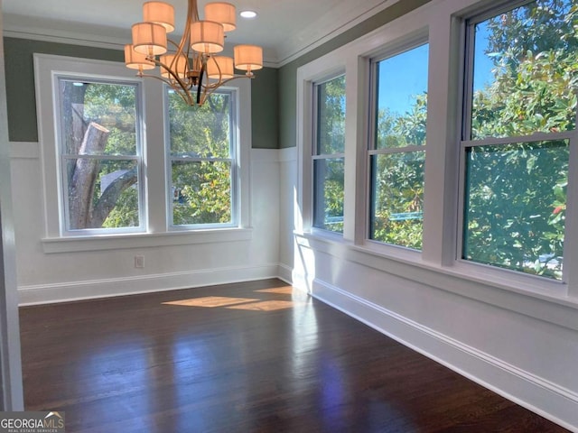 unfurnished dining area featuring baseboards, recessed lighting, dark wood finished floors, and a notable chandelier