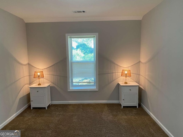 unfurnished bedroom with carpet, visible vents, and baseboards