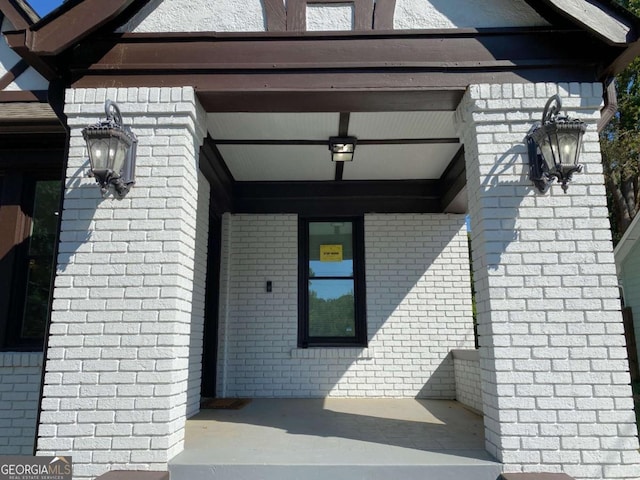 view of exterior entry with brick siding