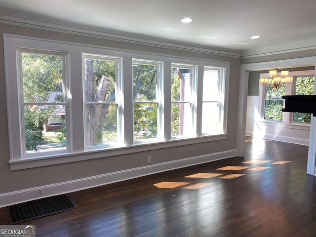 interior space with baseboards, visible vents, dark wood-style flooring, and a notable chandelier