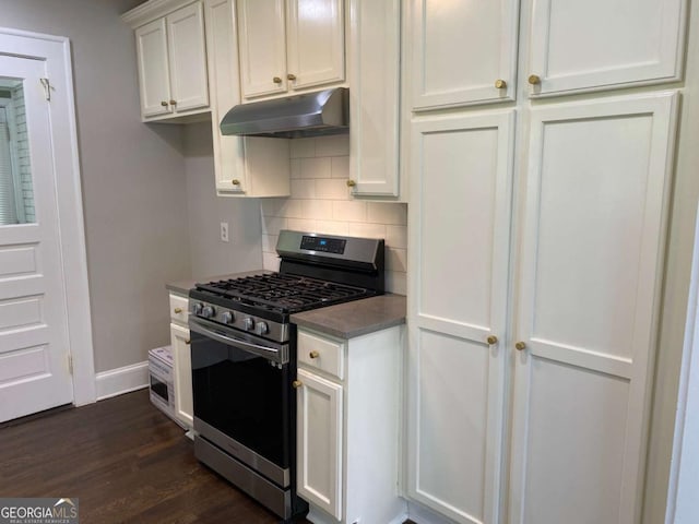 kitchen featuring dark wood-style flooring, decorative backsplash, white cabinetry, stainless steel gas range, and under cabinet range hood