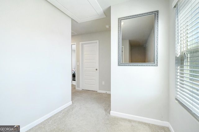 hall with carpet flooring and baseboards