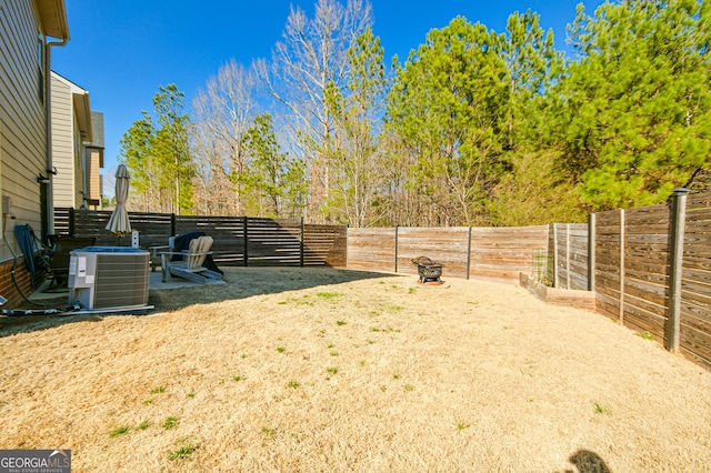 view of yard featuring a fenced backyard and central AC unit