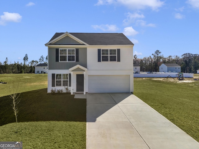 traditional home featuring an attached garage, driveway, and a front lawn